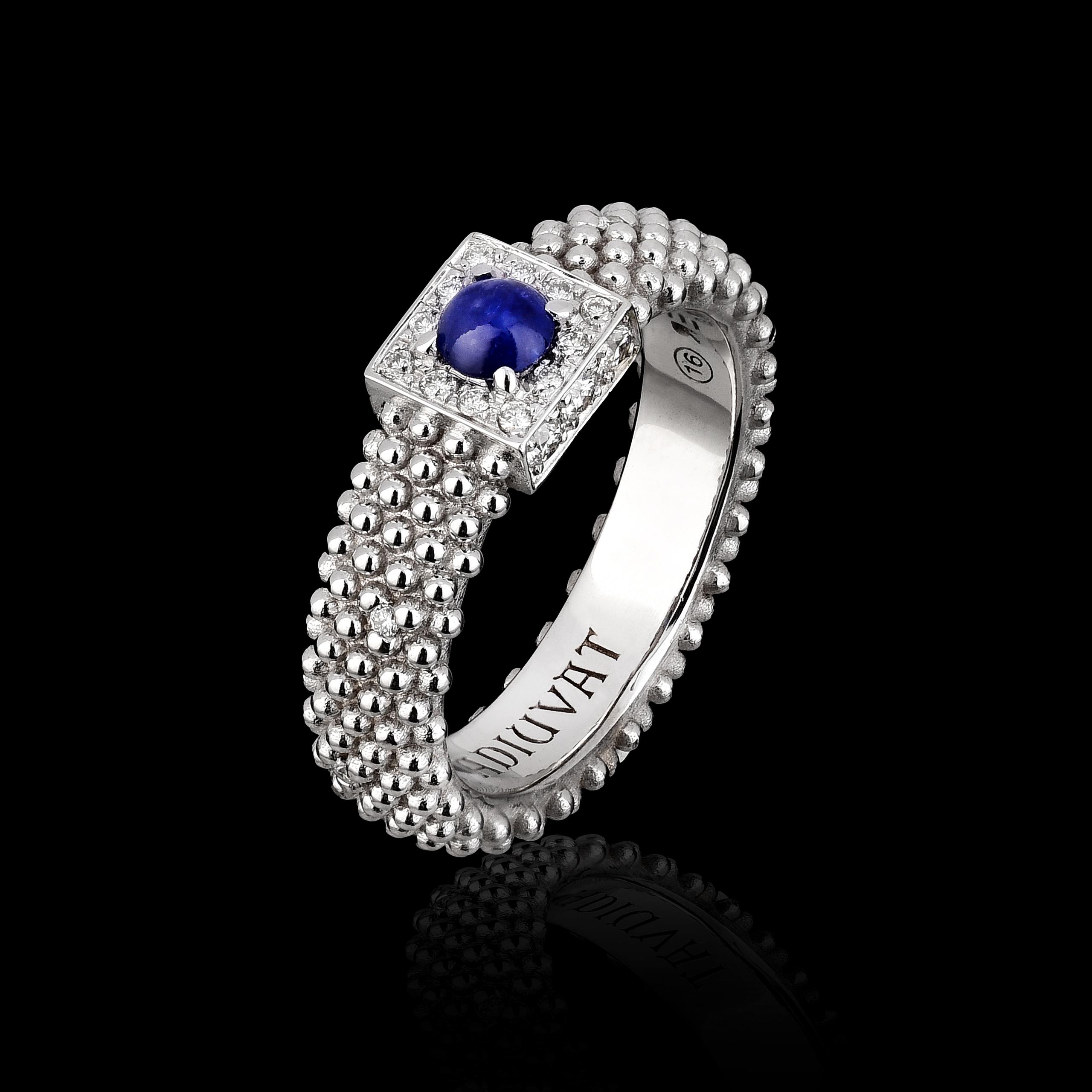 18kt white gold, sapphire center stone with 18 natural white diamonds framing and diamond points