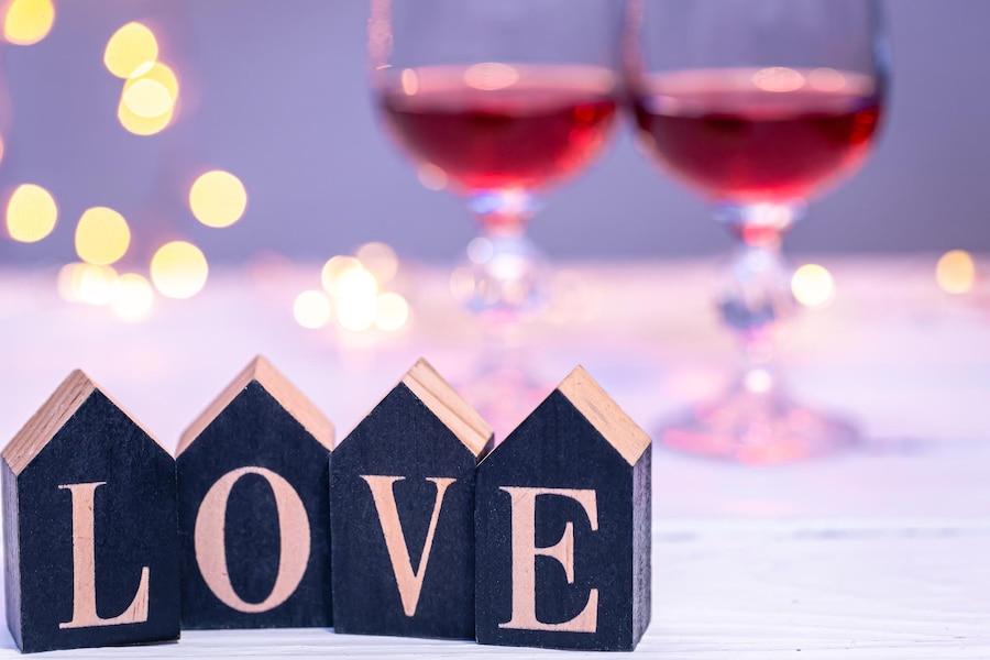 decorative-word-love-blurred-background-with-glasses-wine_169016-25590jpg